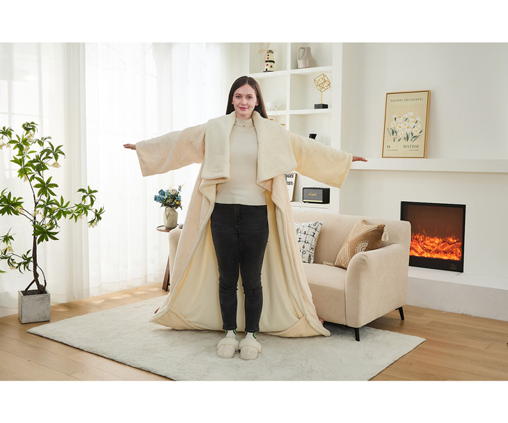 Wearable heated blanket with sleeves and integrated heated foot pocket